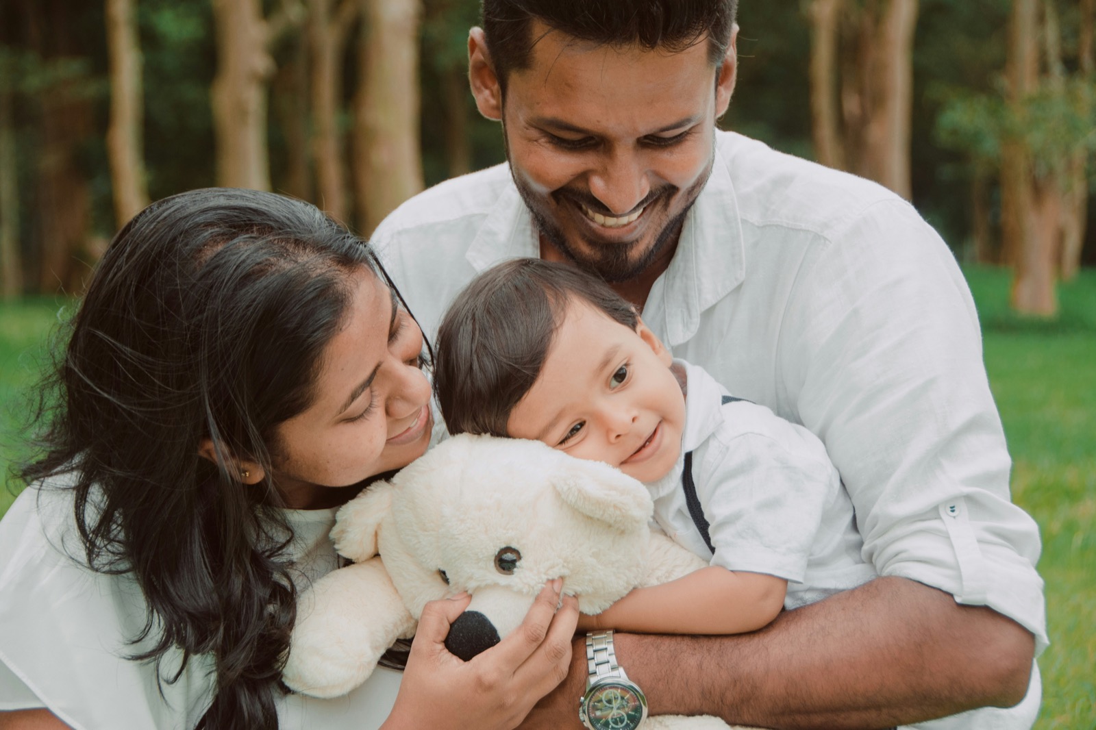 Family with their toddler in a park